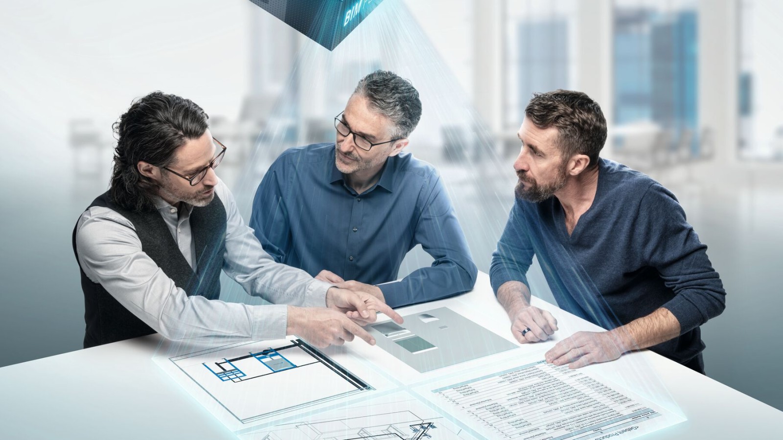 Planners deep in discussion around a table with BIM symbol