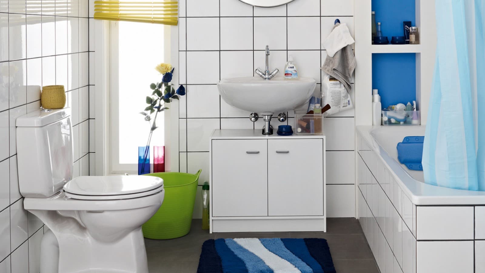 Cluttered bathroom seen before the renovation, with floor-standing toilet and exposed cistern Cluttered bathroom seen before the renovation, with floor-standing toilet and exposed cistern